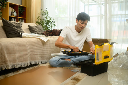 Young asian man checking the assembly guide before for new furniture.