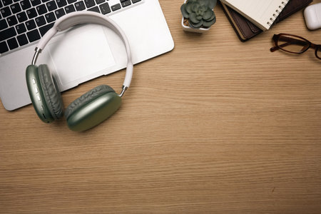 Modern workspace with headphones, laptop, notebook and eyeglasses. Top view, Flat lay.の写真素材