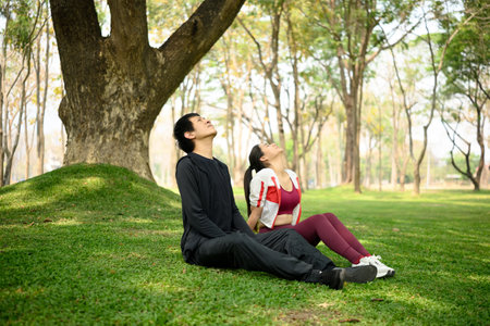Calm asian couple resting after finishing their exercise routine.の写真素材