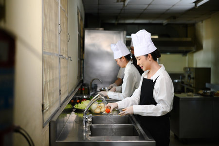 Group of culinary students washing produce in a cooking school.