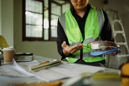 Close up of technician examining cable spools during building renovation.の写真素材