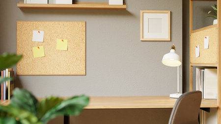 3D rendered minimalist home office desk with corkboard, books, and modern lamp in cozy interior design.の写真素材