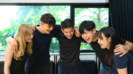 Diverse group of young adults smiling and bonding together after a fitness workout session.