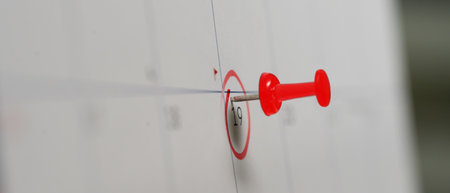Red pushpin marking the 19th on a calendar, symbolizing an important appointment,.
