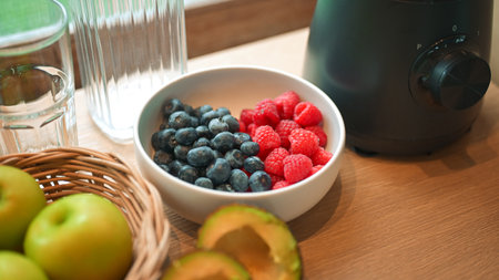 Healthy lifestyle setup in the kitchen. Fresh fruits apples, blueberries, raspberries, and avocado...