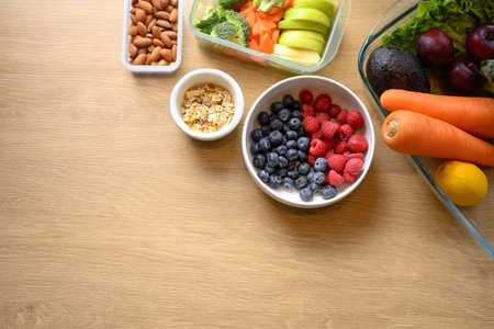Fresh healthy ingredients with fruits, vegetables, and nuts on wooden table for clean eating and wellness lifestyle.の写真素材