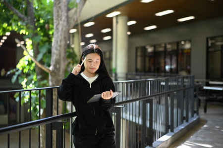 A teenage girl enjoying her creativity through digital art on a tablet.の写真素材