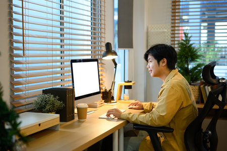 Creative man working on mockup computer with blank screen..の写真素材