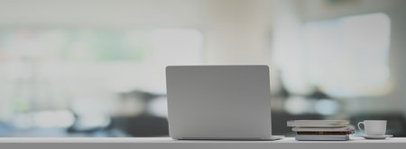 Front view laptop on white table In office workplace. 3D rendering.