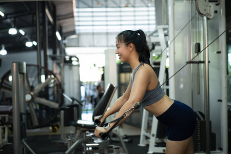 A woman exercise chest workout on cable chest press machine, Fitness and workout concept.の写真素材