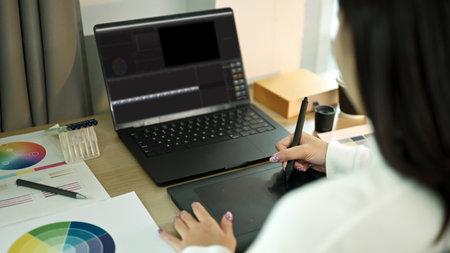 Freelancer woman editing video on computer with professional program in home office.