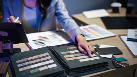 interior designer working on new house project in office. choosing materials and colors from...