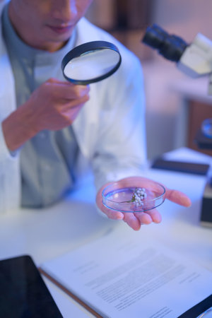 Laboratory workspace with microscope, green chemical solution, and research documents, representing modern scientific analysis and controlled experimentation..の写真素材