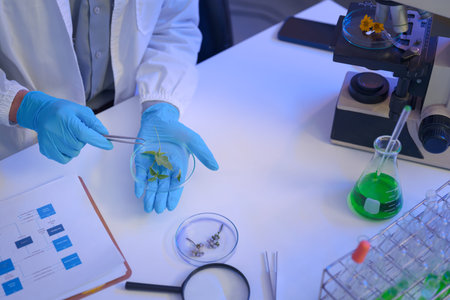 Laboratory workspace with microscope, green chemical solution, and research documents, representing...