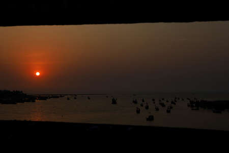 The sunset at a lovely beach crowded by peoples