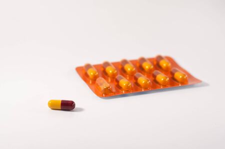 red and yellow capsule separate from packageの写真素材
