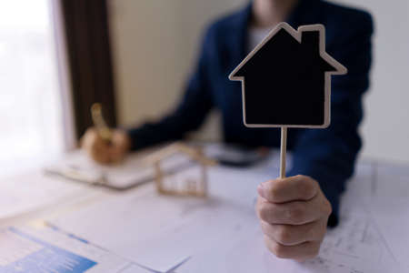 Real estate agents showing house labels with copy space for sale or buy house. House seller and real...