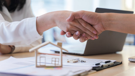 Woman real estate agents or house seller and customers shake hand, After discussing about buying a house successfully. Concept of loan, buying, mortgage for living housing.の写真素材