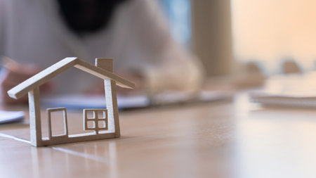 Wood Model house with real estate agents or bank office working about home loan, sale housing, house purchase contract. Banner background and copy space.の写真素材
