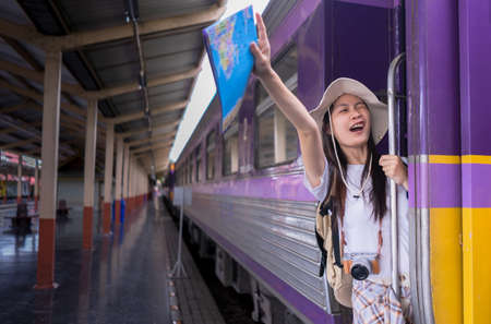 Travel lifestyle. Portrait Young Woman Travelers raising her hand acting glad to travel on the door...