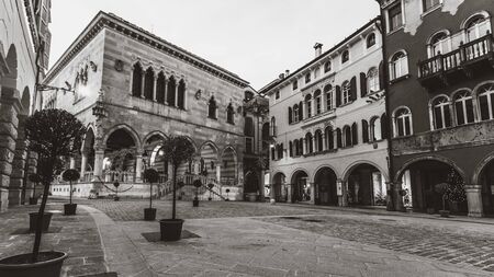 UDINE (ITALY) - JANUARY 03, 2020: The view on the city centre of Udine town, Italy. Ancient Italian square arches and architectureのeditorial素材
