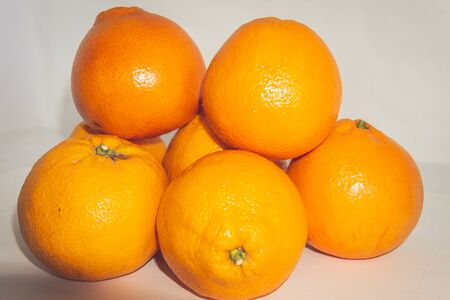 A pile of oranges sitting on a tableの写真素材