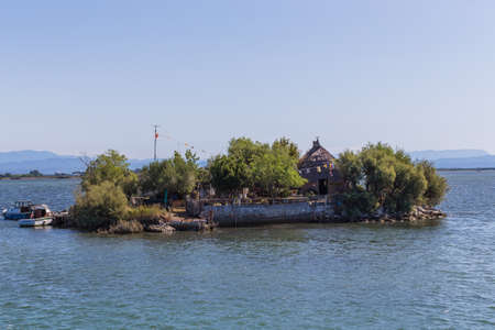 View of Casoni - Grado (GO). Rural building with a sloping roof covered with straw, once widespread in the countryside in the lagoon area of Gradoの写真素材