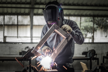 Working welder in action with bright sparks.の写真素材
