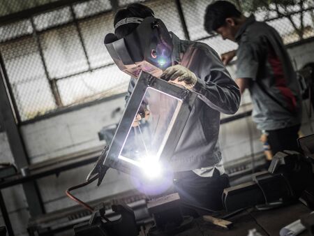 Working welder in action with bright sparks.の写真素材