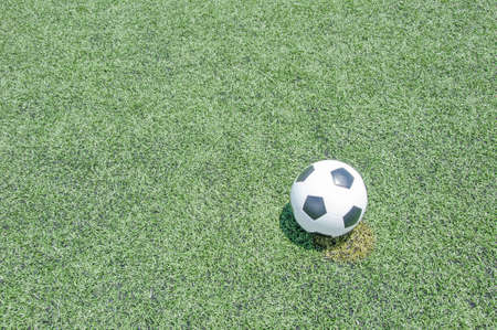 Close up soccer ball on green grass or artificial turf at noonの写真素材