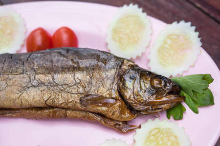 Grilled trout with cucumber and tomatoesの写真素材
