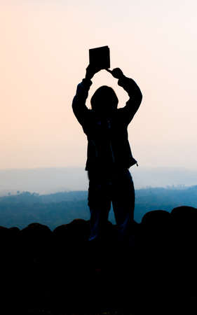 young woman selfie during Sunset on mountain with landscape viewの写真素材