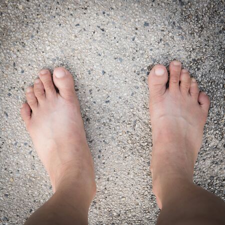barefoot on patterned paving tiles, cement brick floor backgroundの写真素材