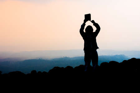 young woman selfie during Sunset on mountain with landscape viewの写真素材