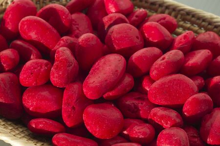 Red stones in basketの写真素材
