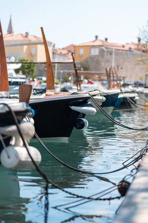 Fishing and tourist boats moored to the pierの写真素材