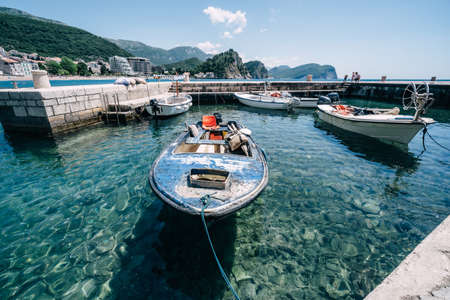 Old fishing boats in clear water in Montenegro