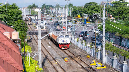 Yogyakarta, Indonesia - Nov 19, 2021: Landscape photo of an Indonesian train moving on the railway....