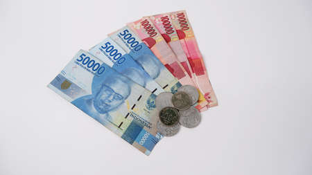 The money of Indonesian rupiah notes in 100 thousand, 50 thousand, one thousand, and five hundred rupiah denominations lined up together with a white background.の写真素材