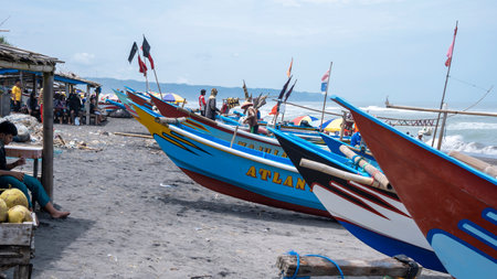 Yogyakarta, Indonesia - March 27, 2022: Fishermen's boats lined up neatly after returning from fishing on Depok beachのeditorial素材