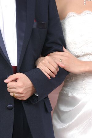 Groom holding brideâs handの写真素材