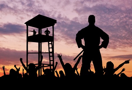 Concept of security. Silhouette of a military border guard on the background of the crowd of refugees and the watchtowerの写真素材