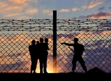 The concept of security. Silhouette of a family with children of refugees and border guards and a...