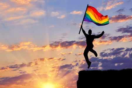 ?oncept of gay people. Silhouette of a happy gay jump on topの写真素材