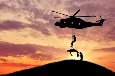 Concept of the evacuation. Silhouette helicopter evacuated the wounded manの写真素材