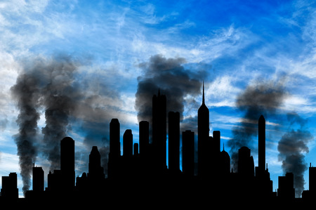 Concept of a terrorist attack. Silhouette of the city in smoke against the blue skyの写真素材