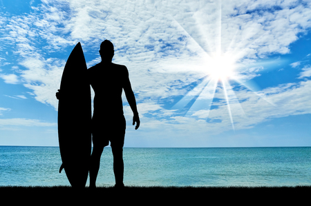 Concept of sport. Surfers silhouette against the sea in the morningの写真素材