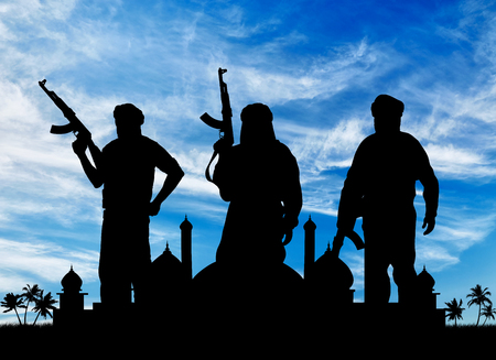 Concept of terrorism. Silhouette of three terrorists with a weapon against a background of sunrise and the Town Hall with palm treesの写真素材