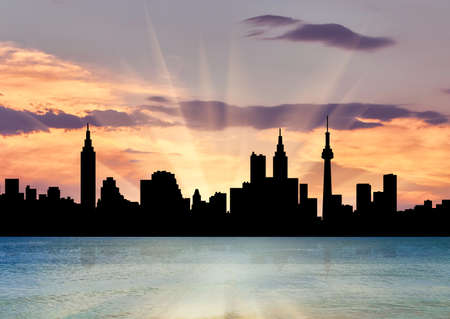 Silhouette of the beautiful scenery of the city against the backdrop of a beautiful sunset seaの写真素材