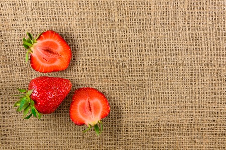 Three ripe strawberries lie on the fabric. Design elementの写真素材